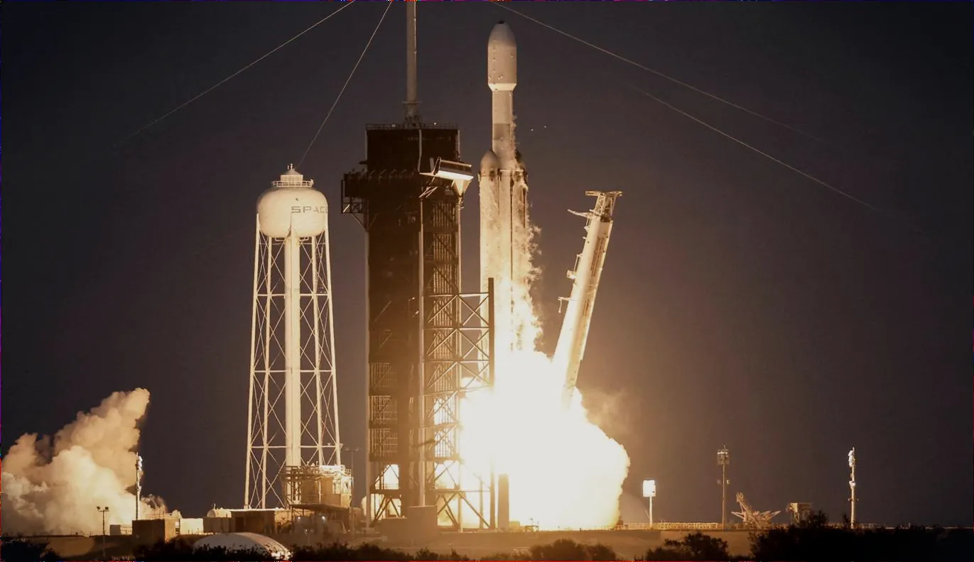 SpaceX Falcon Heavy lifting off at night
